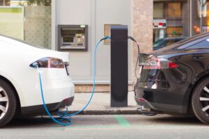 2 electrical vehicles are charging at the battery charging station.