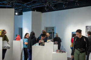 Gallery attendees viewing the different works in ceramics, painting, printmaking, sculpture, photography, and graphic design made by Valley Art students at the Annual Art Student invitational reception. (Ivonne Elias for The Valley Star).